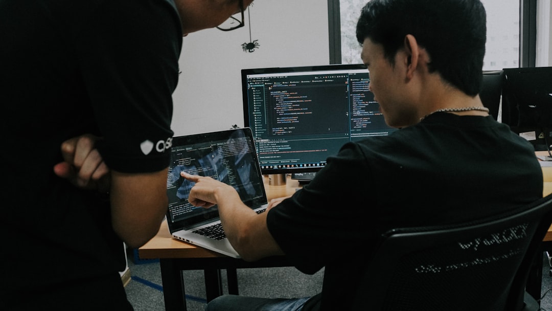 two-men-working-on-computers-in-an-office-rik-i9rxpao